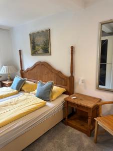 a bedroom with a bed with a table and a mirror at Boardwalk center in Mayrhofen