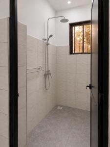 a shower with a glass door in a bathroom at Boma Retreat in Boma la Ngombe +46 photos