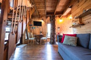 a living room with a blue couch and a table at Xalet De Prades in Prades