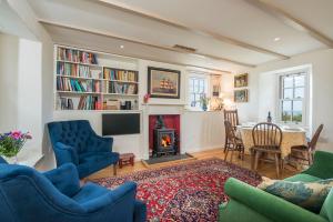 a living room with a fireplace and a table and chairs at The Nant in Haverfordwest