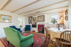 a living room with a table and chairs and a fireplace at The Nant in Haverfordwest