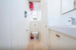 a white bathroom with a toilet and a sink at The Nant in Haverfordwest +32 photos