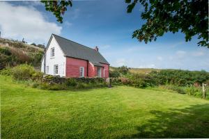 a red and white house on a grass field at The Nant in Haverfordwest