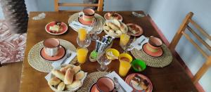 a table with plates of food and glasses of orange juice at YPORA Ldg in Colonia Carlos Pellegrini