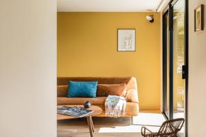 a living room with a couch and a table at Le Moulin de Nouara in Ambert