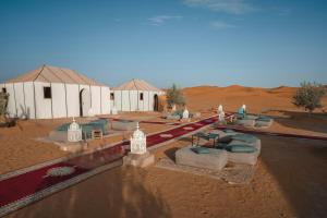 a group of tents in the middle of the desert at Roaming Desert Luxury Camp in Lac Yasmins