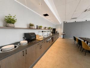 an office with a kitchen with tables and chairs at Hotel Ks in Bad Fallingbostel +5 photos