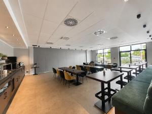 a restaurant with tables and chairs in a room at Hotel Ks in Bad Fallingbostel