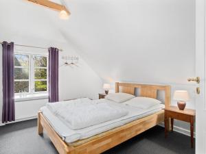 a bedroom with a large bed with purple curtains at Holiday Home Jolanda by Interhome in Bramming