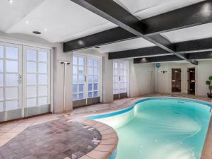 a swimming pool in a building with a large room at Holiday Home Jolanda by Interhome in Bramming