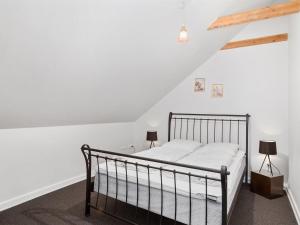 a bedroom with a black bed with two lamps at Holiday Home Jolanda by Interhome in Bramming