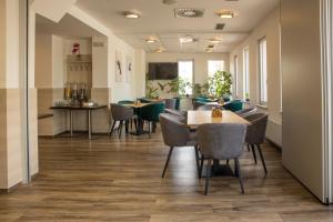 a restaurant with tables and chairs in a room at Hotel Kanarek in Prague