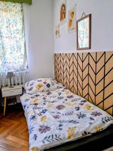 a bedroom with a bed with a comforter on it at Ohrazenice 103 in Turnov +26 photos