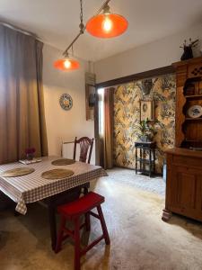 a dining room with a table and a red chair at Appartement Saint Antoine 2 in Toulon-sur-Arroux +6 photos