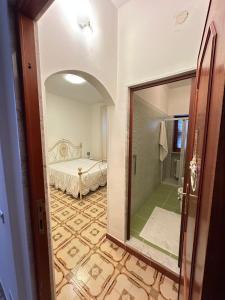 a bedroom with a bed and a mirror in a room at Da mare in Ginosa Marina