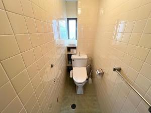 a small bathroom with a toilet in a stall at Lemon みやざき in Miyazaki