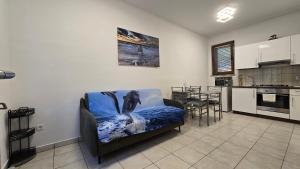 a living room with a couch and a kitchen at Apartment Labin in Labin