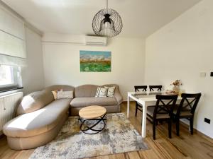 a living room with a couch and a table at Cor Montis Apartments in Krasno Polje