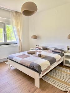 a bedroom with a large bed in a room at Cor Montis Apartments in Krasno Polje