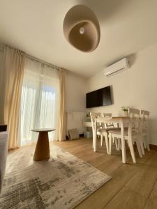 a living room with a table and a dining room at Cor Montis Apartments in Krasno Polje