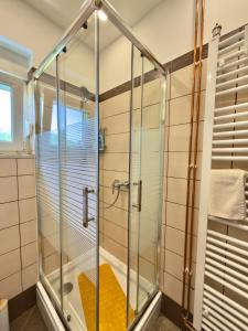 a shower with a glass enclosure in a bathroom at Cor Montis Apartments in Krasno Polje +46 photos