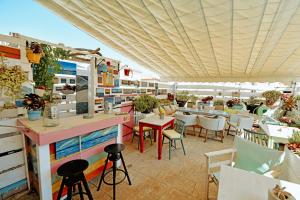a restaurant with tables and chairs on a patio at Mastoris Mansion in Hydra