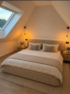 a bedroom with a large bed and a window at Pro Home Elia Maisonette in Bad Oeynhausen