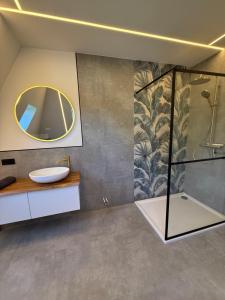 a bathroom with a sink and a mirror at Pro Home Elia Maisonette in Bad Oeynhausen +15 photos