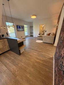 a large living room with wooden floors and a couch at Pro Home Elia Maisonette in Bad Oeynhausen