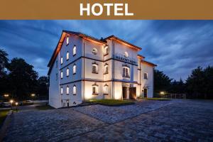 a large white building with the words hotel at Hotel Miodowy Młyn in Opatów
