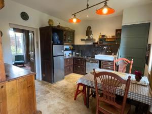a kitchen with a table and a refrigerator at Appartement Saint Antoine 2 in Toulon-sur-Arroux