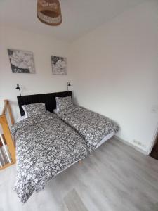 a bedroom with a bed and two pillows on it at L'échappée Verte en Thiérache in Martigny