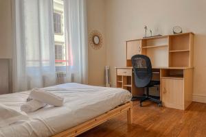 a bedroom with a bed and a desk and a chair at #EU L'Authentique in Grenoble