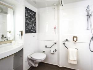 a white bathroom with a toilet and a sink at Ibis Sheffield City in Sheffield +79 photos