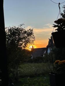 a sunset from the backyard of a house at Haus Sonnenschein in Koserow +2 photos