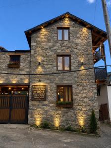 a stone building with a sign on the side of it at Stone House marexi in Adishi
