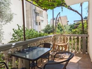 a patio with a table and chairs on a balcony at Apartments Irena in Bečići