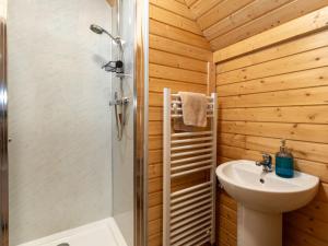 a bathroom with a shower and a toilet and a sink at Chalet Forester's Bothy by Interhome in Coldstone