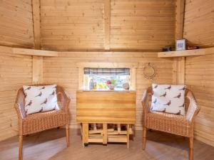 two chairs and a table in a room at Chalet Forester's Bothy by Interhome in Coldstone