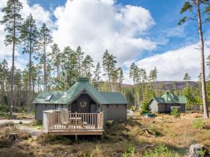 a small house with a porch in a field at Chalet Forester's Bothy by Interhome in Coldstone