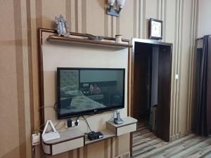 a flat screen tv on a wall in a hotel room at Ashiana in Patiāla