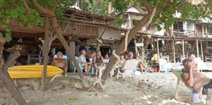 a group of people sitting in chairs on a beach at Changbar Bungalow in Ban Ao Sapparot