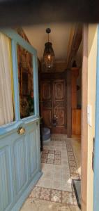 a bathroom with a blue door and a toilet at Appartement Saint Antoine 2 in Toulon-sur-Arroux
