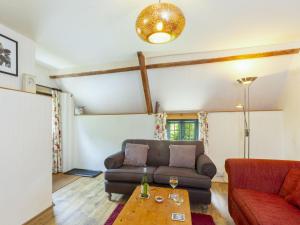 a living room with a couch and a table at Apartment The Appleloft suite by Interhome in Holsworthy
