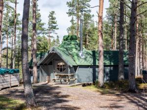 a cabin in the woods with a green roof at Chalet Beekeepers Bothy by Interhome in Coldstone