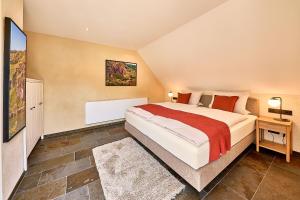 a bedroom with a large bed in a room at Wohnen am Weingut - Auf dem Ausguck in Briedel +25 photos