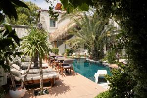 a swimming pool with lounge chairs and a hotel at The ABC Hotel in Alaçatı