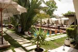 a courtyard with tables and chairs and a palm tree at The ABC Hotel in Alaçatı