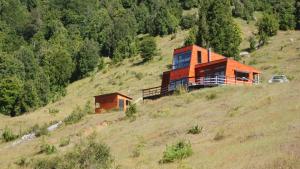 a house sitting on top of a hill at Das Glashaus in Curacautín