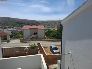 a car parked on the side of a building at Apartmani T'n'T in Pag
